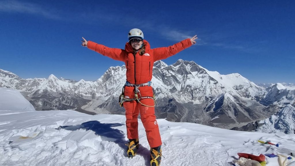 A photo of Adrianna Brownlee atop a mountain