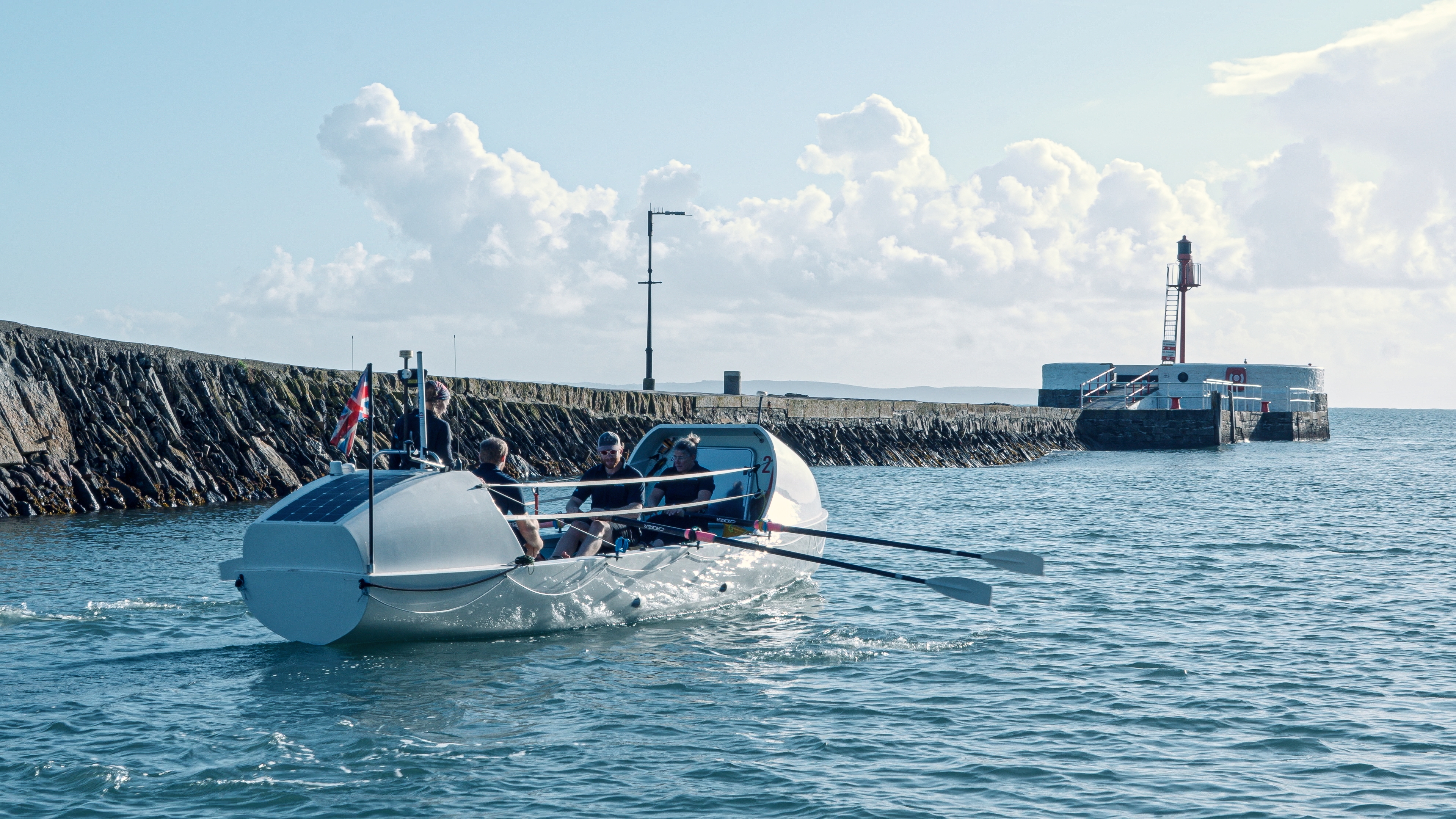 The Oars of Thunder rowing team rowing on the ocean.