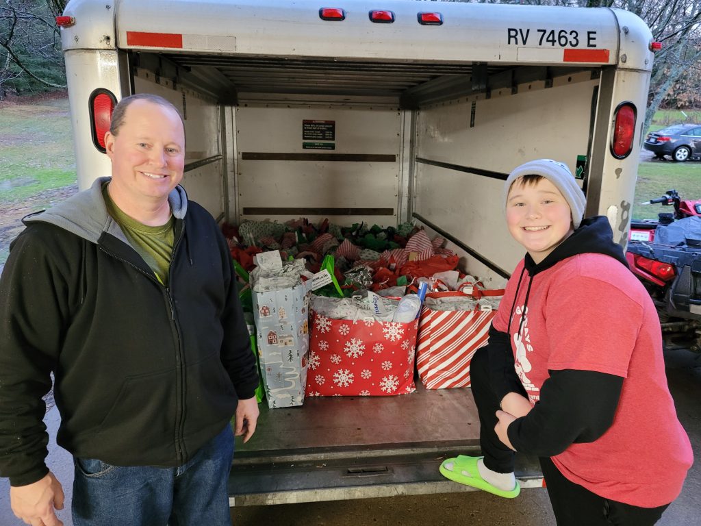 Riley's Warriors load a van with gifts for children in hospitals